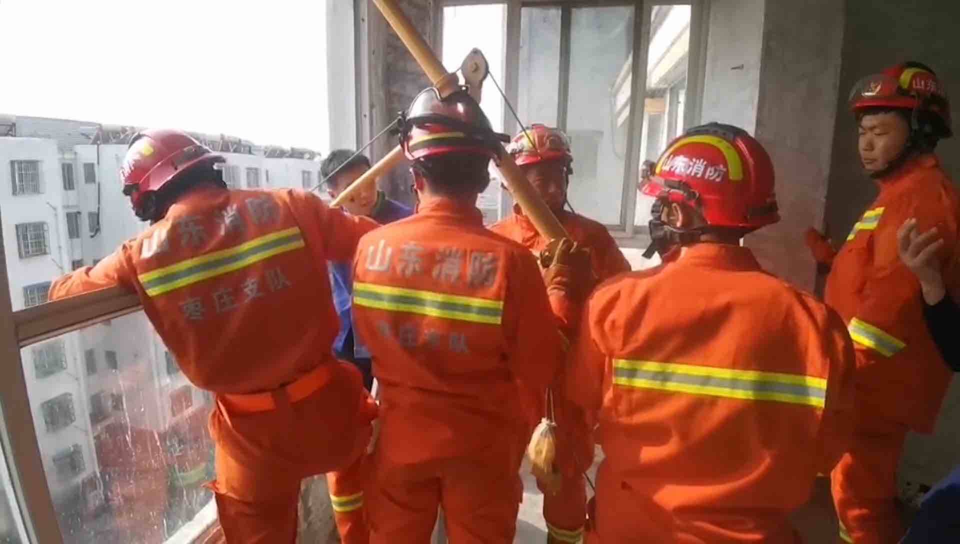 吊机侧滑把工人压在6楼阳台  5名消防员破窗救人